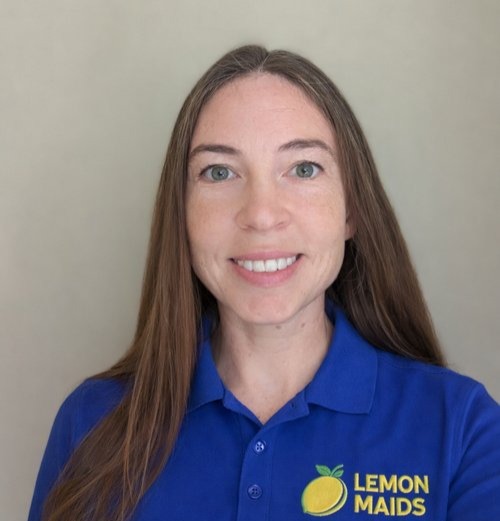 Anna, owner and cleaner at Lemon Maids, wearing a branded Lemon Maids polo shirt